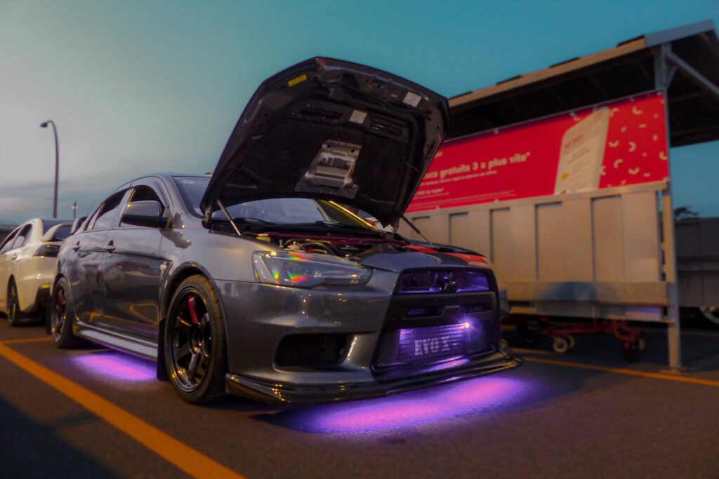 Grey Mitsubishi EVO X with purple underglow lights