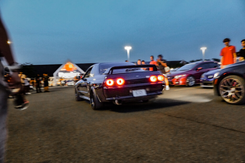 Nissan GTR R33 driving in a parking lot