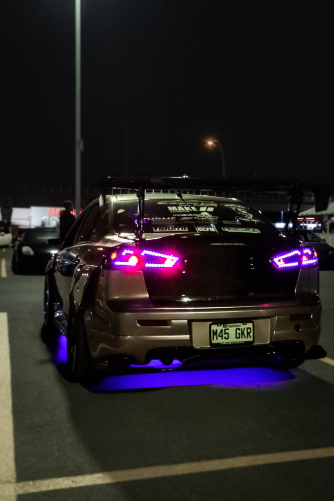 Mitsubishi Lancer with Sakura flowers on the side and purple tail lights