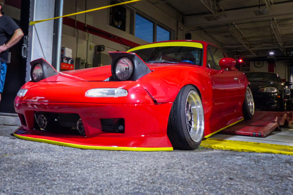 Red Miata low to the ground